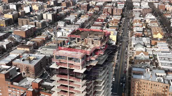 A high angle view above a new high-rise construction site in Brooklyn, NY. The drone camera zoom in,