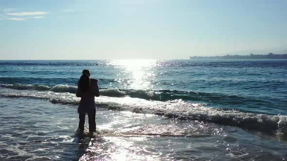 Beautiful People Married on Vacation Spend Quality Time on Beach on White Sand