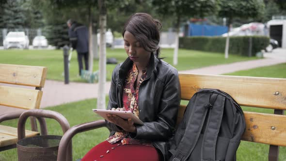 Laughing Young African American Female Holding a Touch Pad Tablet PC Outdoor, Black Student After