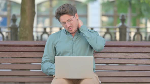 Middle Aged Man having Neck Pain while Typing on Laptop