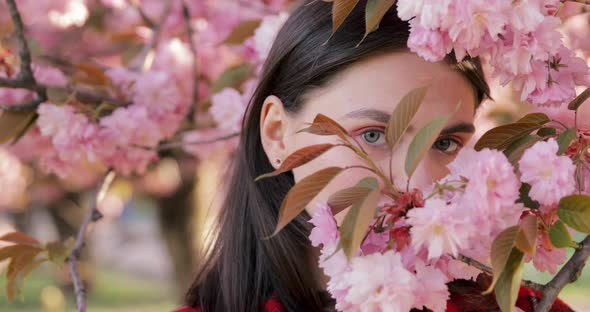 Portrait beautiful mixed race millenial woman smiling hiding face and looking at camera