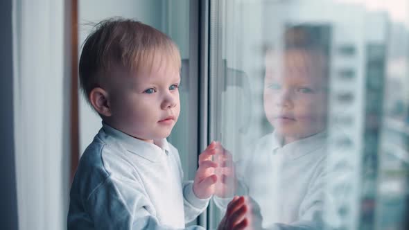 Childhood During Lockdown a Little Kid on Home Quarantine Looking Out the Window Selfisolation in