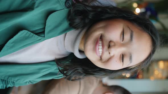 Portrait of Cheerful Asian Woman in Cafe