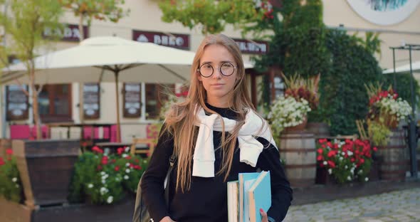 Female Student in Formal Clothes in Glasses with Books which Looking at Camera 