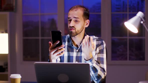 Caucasian Entrepreneur Talking During a Video Call on His Phone