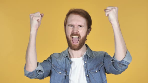 Redhead Man Celebrating Success, Yellow Background