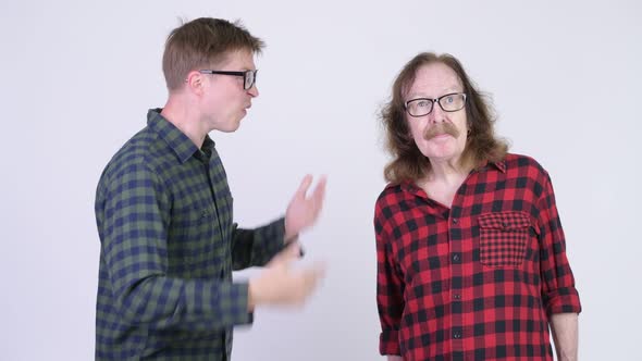 Young Hipster Man Getting Angry at Happy Senior Hipster Man