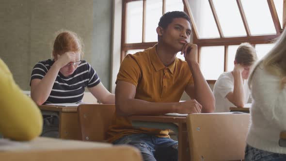 Mixed race boy thoughtful in class