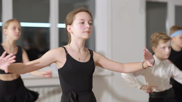 Portrait of Confident Brunette Slim Girl Dancing Latin Dance in Slow Motion in Dance Studio