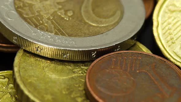 Euro coins of different values: one uro, two euro, cents, etc. Macro shot, rotating view in 4k.