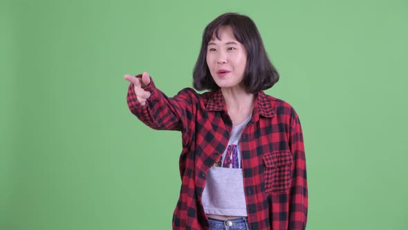 Happy Asian Hipster Woman Pointing Finger