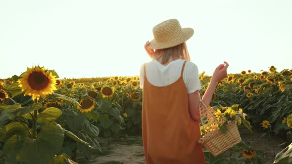 A Smiling Woman is Carrying a Basket of Flowers