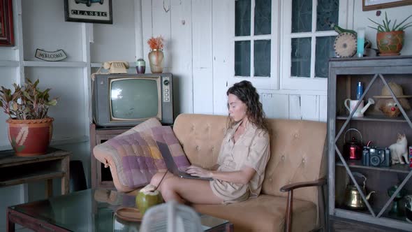 Woman Works on Her Laptop on Vintage Terrace with Old Tv Set Summer Coast Villa