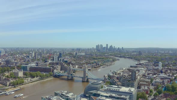 Slider drone shot of Tower bridge and canary wharf on a sunny day