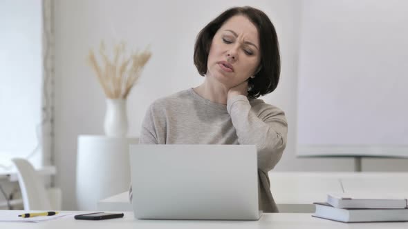 Tired Old Senior Woman with Neck Pain Working on Laptop