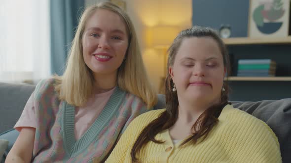 Portrait of Cheerful Woman and Girl with Down Syndrome at Home