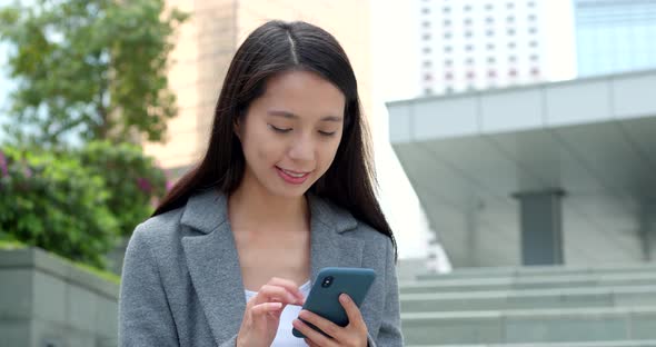 Businesswoman use of smart phone in city