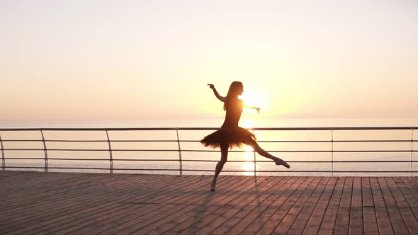 Young Woman in Black Tutu Doing Ballet at the Seafront