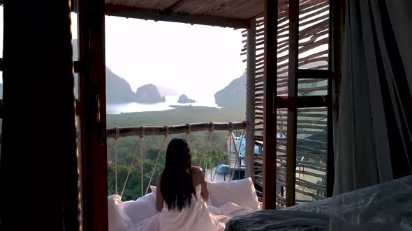 Phangnga Bay Asian Woman Waking Up in Bed in Nature Jungle Looking Out Over Ocean and Jungle During