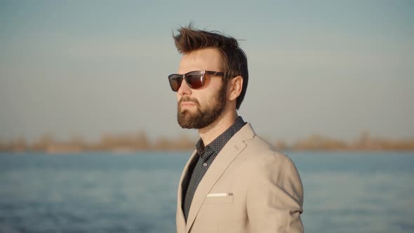 Man In Sunglasses Staying And Watching To Horizon. Handsome Man Thinking And Relaxing.