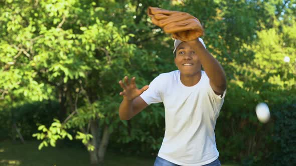 African Young Man Failing to Catch Baseball, Sport Training Outdoors, Activity