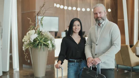 Couple with Luggage in Hotel Lobby