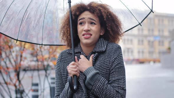 African American Girl Curlyhaired Sad Woman in Stylish Coat Stands in Autumn on City Street with