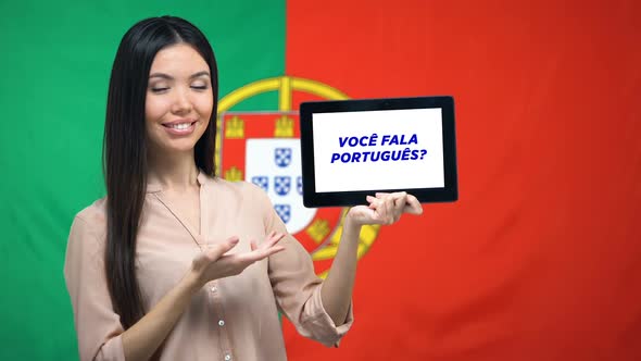 Woman Holding Tablet With Do You Speak Portuguese Phrase, App Learning Language