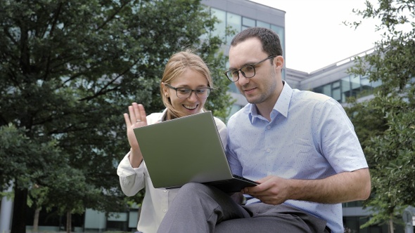 Smiling Happy Couple with Laptop Computer Having Video