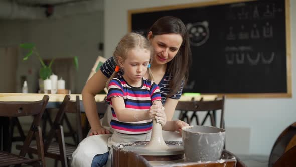 Mother and Daughter in a Pottery Workshop