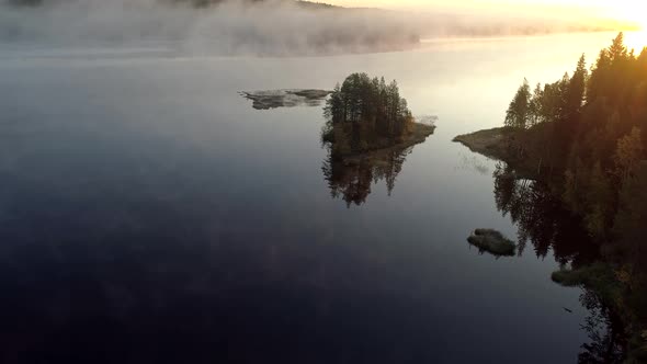 Finland, Wonderful Sunrise on Misty Lake in the Morning, Flying Above Lake Water, Trees Reflecting