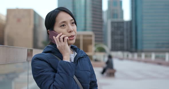 Woman Talk to Cellphone in City