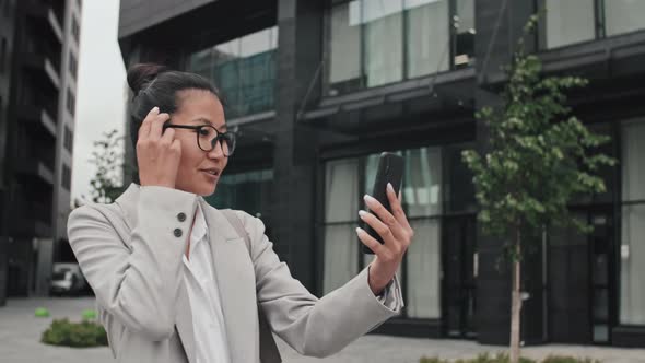 Businesswoman Walking Outside and Talking on Video Call