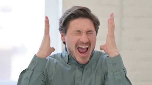 Portrait of Attractive Middle Aged Man Screaming, Shouting