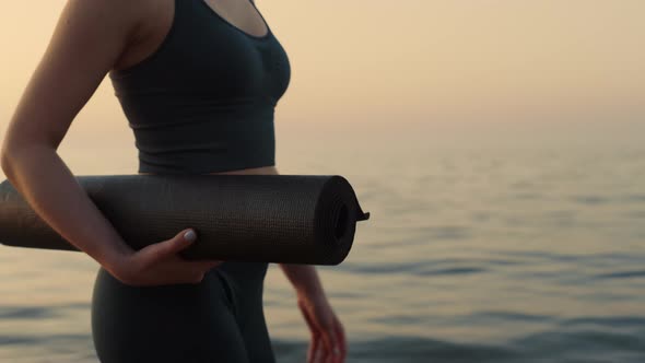 Closeup Fit Woman Walking Seashore with Sport Mat