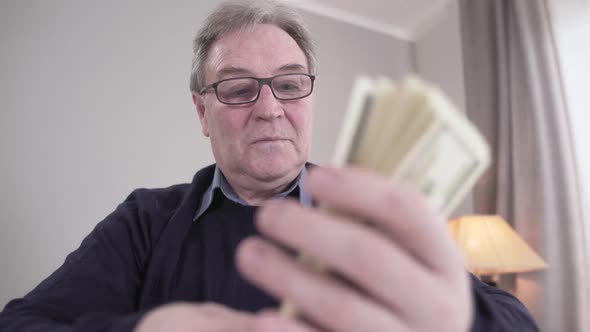 Cash Fan Putting in Bunch, Senior Caucasian Man in Eyeglasses Smiling, Portrait of Rich Retiree