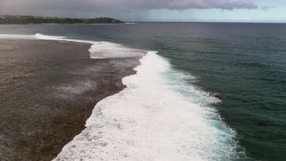 Waves Crash Against a Coral Reef on the Island of Mauritius in the Indian Ocean