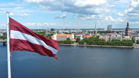 Latvian Flag with the Dome Cathedral and an Old Town in the Background in Riga Latvia