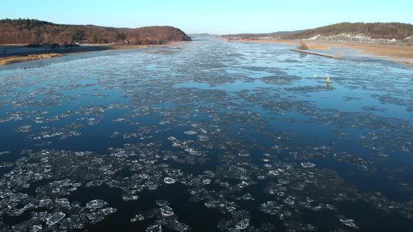 Flying Over Melting Ice On Gota Alv River Winter in Sweden Scene Aerial