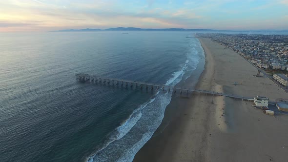 Aerial shot of a scenic beach city and ocean at sunset