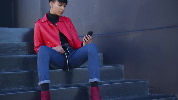 Transgender adult using a phone in the street