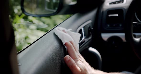 Car Cleaning Concept. The Man's Hand Cleans the Car From the Dust Using a White Cloth.