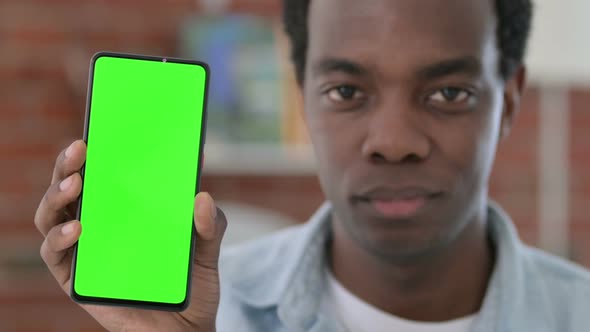 African Man Holding Green Chroma Key Smartphone