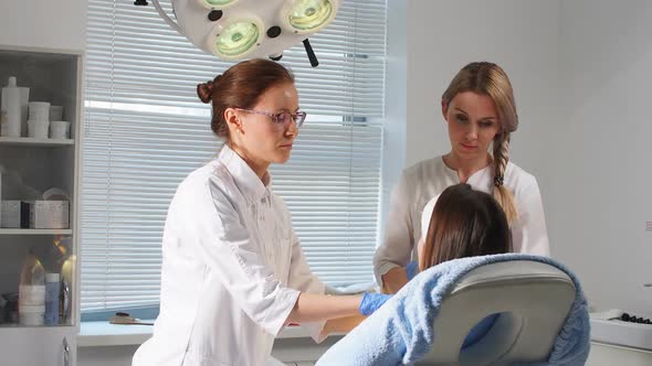 Two Doctors Consulting a Client After Surgery.