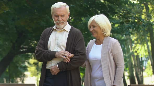 Elder Couple Hugging and Walking at Summer Park, Enjoying Pastime Together