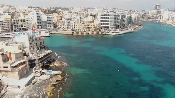 Panning aerial 4k drone footage revealing the cityscape of the densely populated island town, Sliema