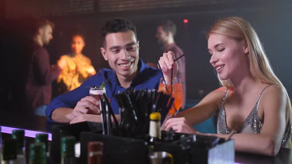 Man Getting Acquainted with Blonde Woman in Bar