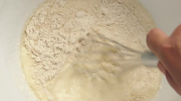 Hand Whisking Flour Mixture In Bowl