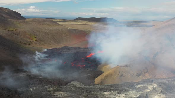 Erupting Volcano Scenery In Volcanic Crater With White Smoke Plume Coming From Glowing Hot Lava In F