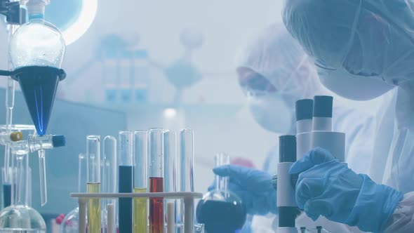 Close Up Handheld Shot of Chemists Working in a Laboratory Filled with Fumes or Smoke alt
